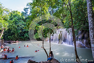 Kanchanaburi, Thailand-October 14, 2023 : Tourists wear life jackets while playing in waterfalls on holiday, beautiful waterfall Editorial Stock Photo