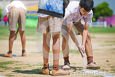 KANCHANABURI THAILAND - OCTOBER 8 : Unidentified Students help Editorial Stock Photo