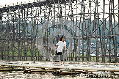 Sangklaburi or Myanmar tall wooden bridge on Songaria River Editorial Stock Photo