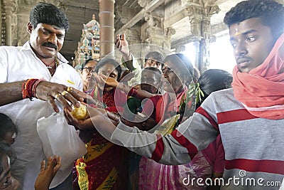 Indian man gives laddu treats to pilgrims Editorial Stock Photo