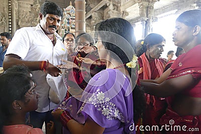 Indian man gives laddu treats to pilgrims Editorial Stock Photo