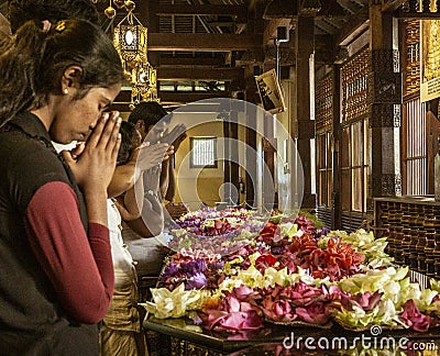 Kandy, Sri Lanka - 09-03-24 - People Place Flowers on Dais and Then Pray to Hindu Gods Editorial Stock Photo