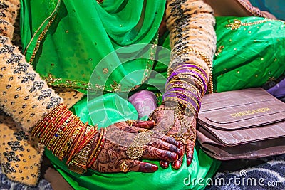 The jeweled and henna decorated hands of a young bride at a village wedding in Jammu and Kashmir Editorial Stock Photo