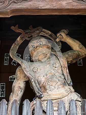 Buddhist guardian deity statue inside the entrance gate of Kannonji and Editorial Stock Photo