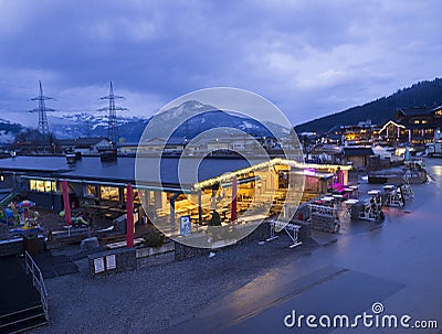 KAPRUN, AUSTRIA, March 13, 2019: Nigt outdoor view on illuminated Kaprun next to cable station with Apres ski restaurant Editorial Stock Photo