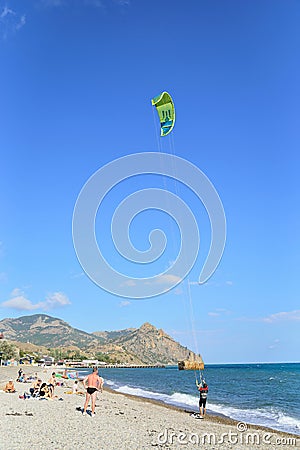 The man in the wetsuit will start on the kite Editorial Stock Photo