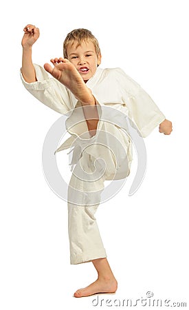 Karate boy kicking by left leg Stock Photo