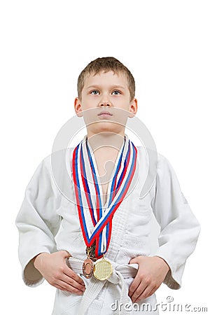 Karate boy in white kimono with medals fighting Stock Photo