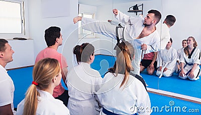 Karate coach teaching adults Stock Photo