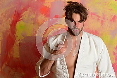 Karate fighter with fit strong body gets ready to fight Stock Photo