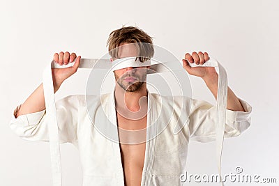 Karate fighter with strong body holds white belt. Stock Photo