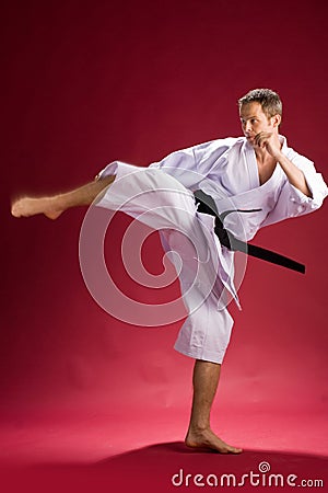 Karate kick by black belt Stock Photo