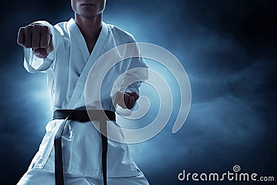 Karate martial arts fighter on dark background Stock Photo