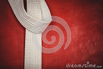 Karate white belt on red background Stock Photo