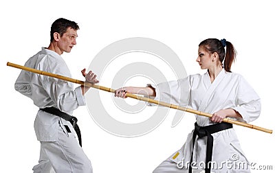 Karate. Young girl and a men in a kimono with a white background Stock Photo