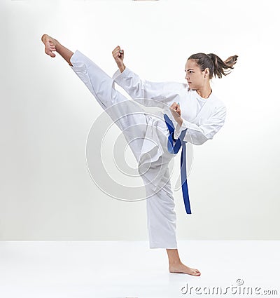 In karategi, a sportswoman strikes a kick Stock Photo