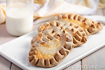 Karjalanpiirakat, Karelian pasties on a rustic table Stock Photo