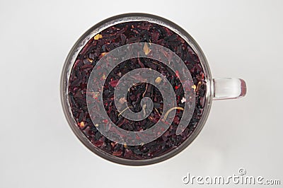Tea drink in a glass. Red liquid in a glass. Dried petals. Hibiscus. Sudanese rose Stock Photo