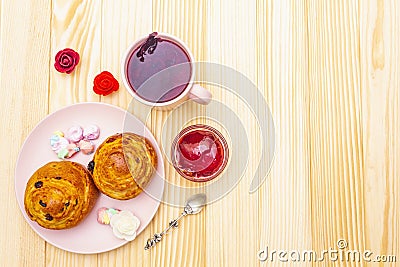 Karkade tea from hibiscus petals Sudanese rose. Gentle romantic breakfast concept. Buns, meringues, strawberry jelly. On a Stock Photo