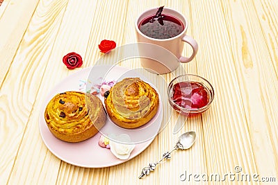 Karkade tea from hibiscus petals Sudanese rose. Gentle romantic breakfast concept. Buns, meringues, strawberry jelly. On a Stock Photo
