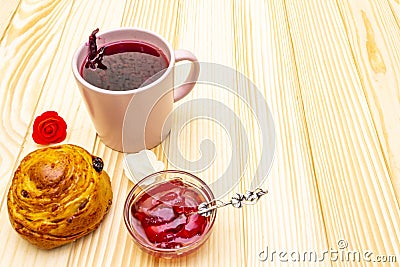 Karkade tea from hibiscus petals Sudanese rose. Gentle romantic breakfast concept. Buns, meringues, strawberry jelly. On a Stock Photo