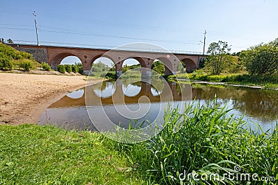 Karlino, Zachodniopomorskie / Poland - August, 7, 2020: Old brick railway bridge over a small river. Brick building in Central Stock Photo