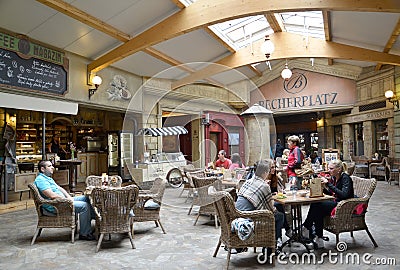 KARLOVY VARY, CZECH REPUBLIC. Visitors to Becherplatz cafe sit at tables Editorial Stock Photo
