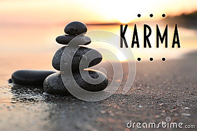 Karma concept. Stones on sand near sea at sunset Stock Photo