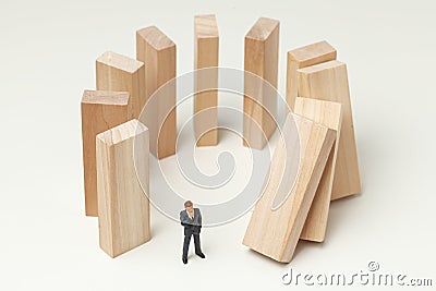 Karma like falling dominoes. Businessman pushed dominoes and expects and analyzes the result. Dangerous situation Stock Photo