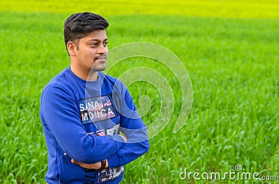 Kashipur, India 2020: Young Indian boy with french cut beard looking sideways and posing for photograph. He is wearing blue shirt Stock Photo