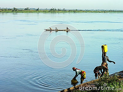 Katanga, DRC: Women fetching water from river Congo Editorial Stock Photo