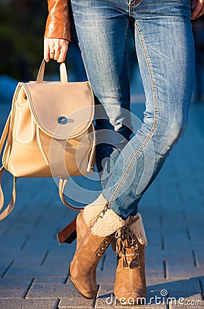Kate_Volovikova. Woman legs boots and handbag backpack Stock Photo