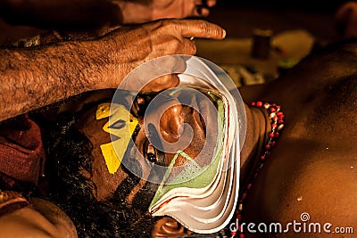 Kathakali exponent preparing for performance by applying face make-up Editorial Stock Photo