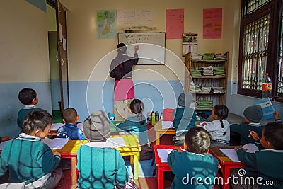 Children in classroom, teacher writes on whiteboard, Kathmandu, Nepal Editorial Stock Photo