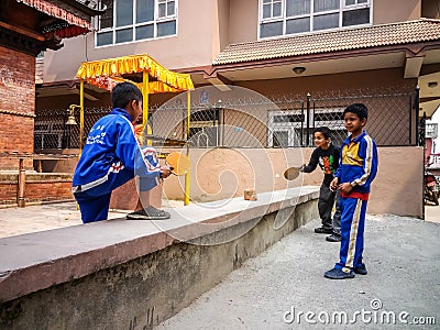 Kids playing ping-pong on the street of Kathmandu Editorial Stock Photo