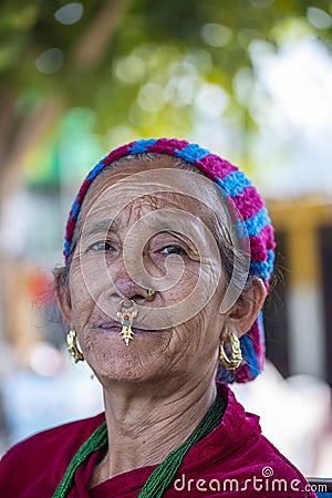 Elderly Nepali woman with traditional nose jewelry on the street market in Kathmandu, Nepal Editorial Stock Photo