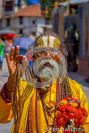 KATHMANDU, NEPAL OCTOBER 15, 2017: Portrait of Nepalese sadhu man holding in his hands a prayer beads on the street of Editorial Stock Photo