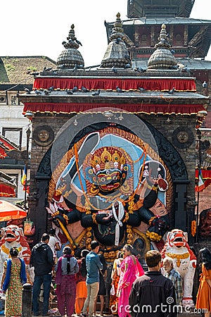 Kathmandu, Nepal - October 2019: Prayers near the statue of Kal Bhairav in Durbar Square during the Dashain Festival Editorial Stock Photo