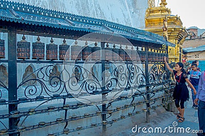 KATHMANDU, NEPAL OCTOBER 15, 2017: Unidentified people walking at outdoors close to Nepalese religious carvings and Editorial Stock Photo