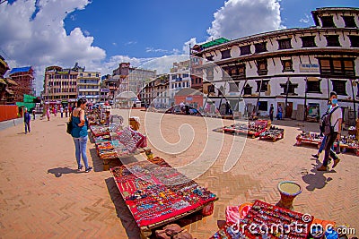 KATHMANDU, NEPAL OCTOBER 15, 2017: Unidentified people walking in a the square with lots of colorful souvenirs in street Editorial Stock Photo