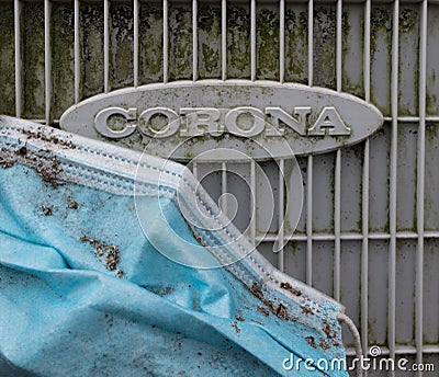 Old Corona, Covid19 mask disregarded on an old rusty piece of electrical equipment Editorial Stock Photo