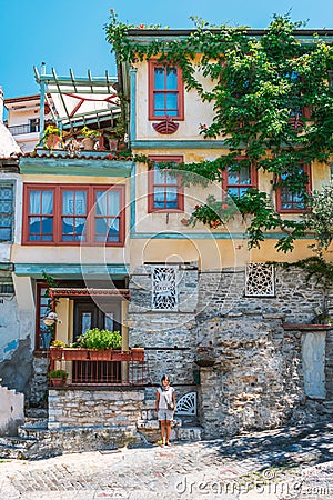 Kavala, Greece, 15/07/2019: Streets of ancient Greek city by the sea and its unique architecture. Girl standing in front of the Editorial Stock Photo