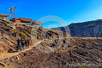 Tourists use a service cart to visited to see view of Ijen crater lake and blue flame early morning Editorial Stock Photo