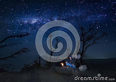 Kawah Ijen sulphur miner resting below tree after finishing his mining activities for the Editorial Stock Photo