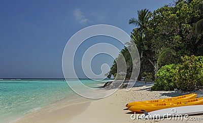 Kayak on the beach. kayaks at beautiful tropical beach with palm trees, white sand, turquoise ocean water at Thinadhoo Islands Stock Photo