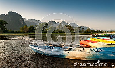 Kayak and longtail boats in Nam Song river Stock Photo