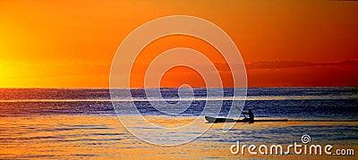 Kayak in ocean at sunset Stock Photo