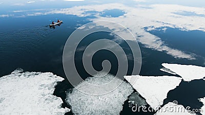 Kayak sailing between ice floes on the lake Stock Photo