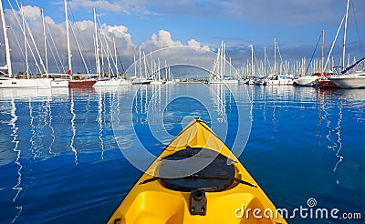 Kayak sailing in a marina port with boats Stock Photo