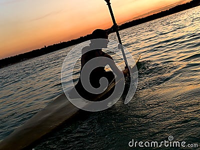 Kayaker against sunset Stock Photo